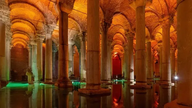 Rows of illuminated columns reflected in the still water of the Basilica Cistern