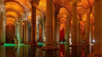 Rows of illuminated columns reflected in the still water of the Basilica Cistern