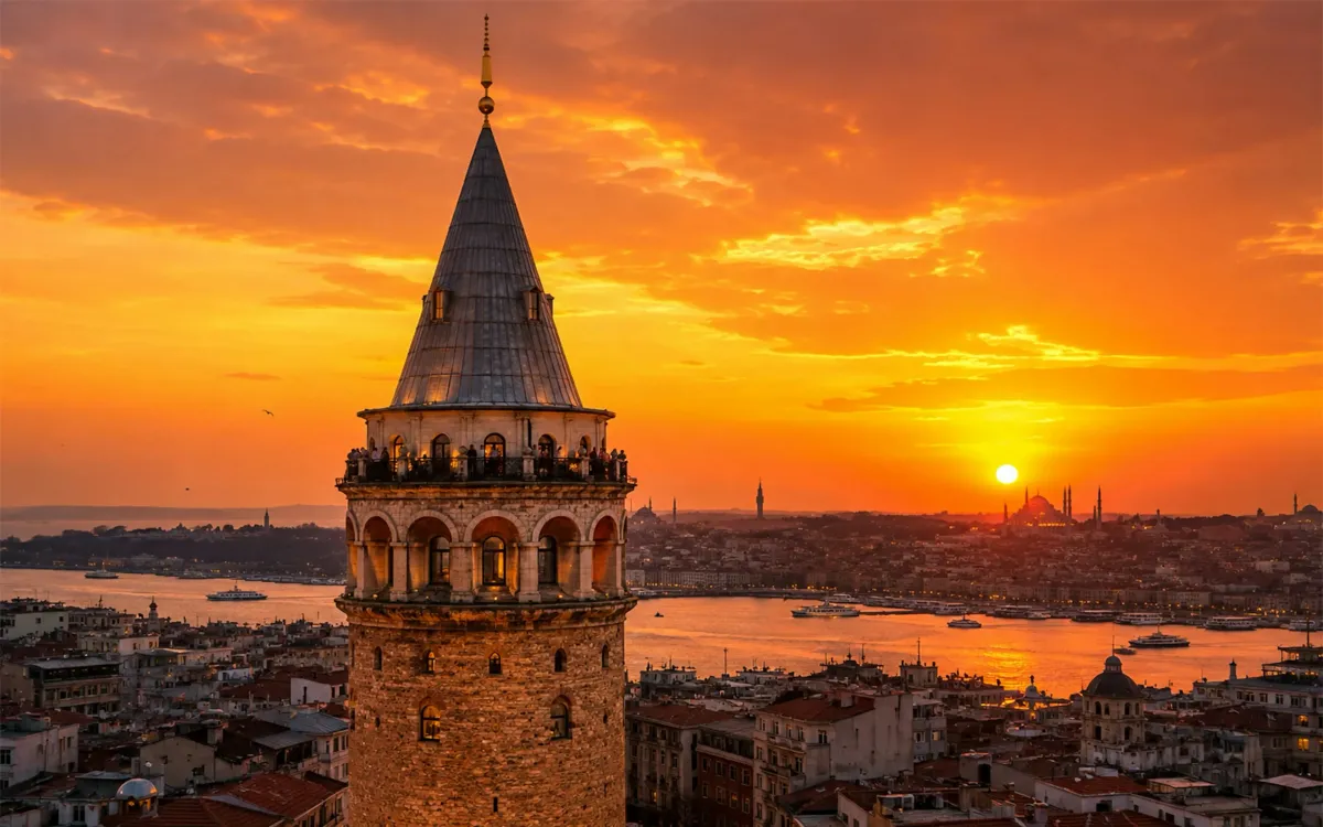 The Galata Tower rising above the rooftops of Karakoy at sunset