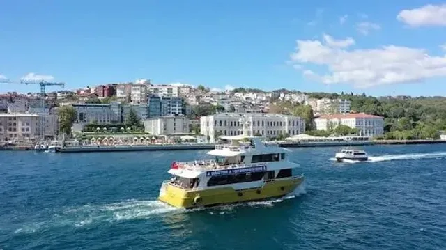 The waterfront promenade and modern buildings of Galataport Istanbul at dusk