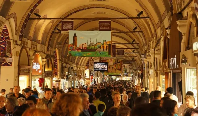 A vaulted, painted ceiling above a busy shopping alley inside the Grand Bazaar