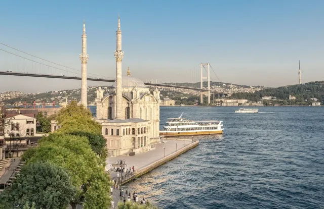 Ferries crossing the Bosphorus strait with the Istanbul skyline in the background